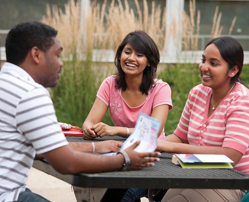 Multiple international students having a conversation outside on Mies campus